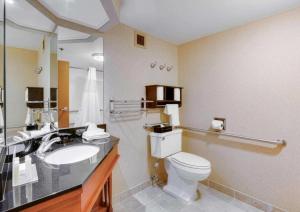 a bathroom with a toilet and a sink at Pittsburgh Airport Inn and Suites in Coraopolis +15 photos