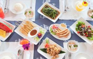 a table with plates of food on it at Koh Kood Beach Resort in Ko Kood
