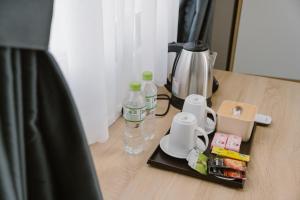 a table with bottles of water and a coffee maker at SmartCity Hometel in Can Tho