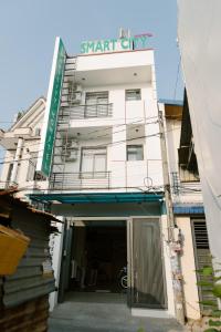 a white building with a sign on top of it at SmartCity Hometel in Can Tho