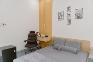 a bedroom with a bed and a desk and a chair at SmartCity Hometel in Can Tho +29 photos