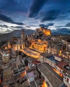 a view of a city at night at Nonno Turiddu Elegant Rooms in Caccamo