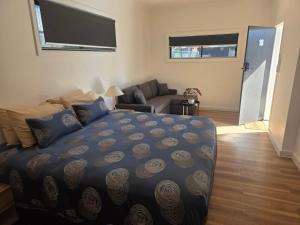 a bedroom with a bed and a living room at Heritage City Motor Inn in Broken Hill