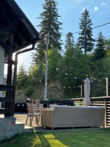 a patio with a table and a statue in the yard at 30 Forest, Azuga in Azuga