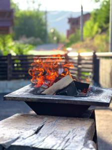 a fire pit with flames on top of it at 30 Forest, Azuga in Azuga