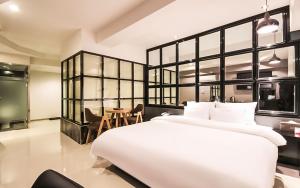 a bedroom with a large white bed and a table at Boutique Hotel Aria Nampo in Busan +74 photos