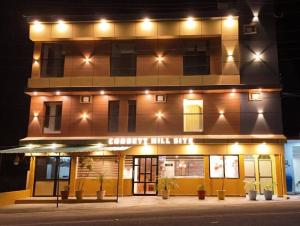 a building with lights on the front of it at Corbett Hill Site in Rāmnagar +4 photos