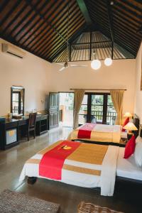 two beds in a hotel room with a bathroom at Liberty Dive Resort in Tulamben +162 photos