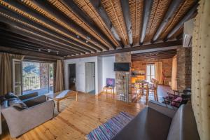 a living room with a wooden ceiling with beams at Farmakas Living in Pharmakas