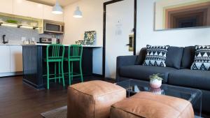 a living room with a couch and a table at The Sobro Guest House by AvantStay in Nashville +8 photos