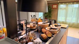 a counter with many different types of food on it at Campanile Marmande in Marmande