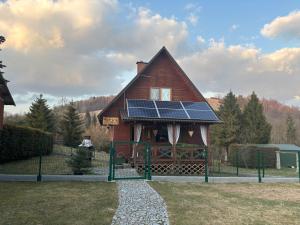 a house with solar panels on the front of it at Domek Jaśka in Baligród