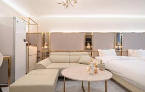 a living room with a bed and a couch and a table at H-AVENUE Hotel Yeongdeungpo in Seoul +66 photos