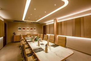 a conference room with a long table and chairs at Purple Elephant Luxury Business Hotel in Cochin