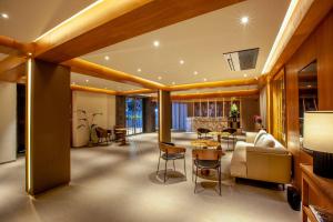a living room with a couch and a table at Purple Elephant Luxury Business Hotel in Cochin
