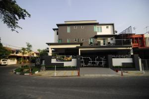 a building with a parking lot in front of it at i-homey guesthouse in Alor Setar