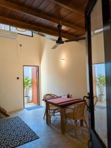 a dining room with a table and chairs at Mariposa Hiriketiya in Dickwella