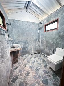 a bathroom with a toilet and a sink at Mariposa Hiriketiya in Dickwella +25 photos