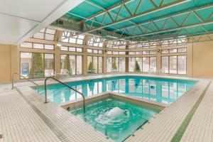 a large swimming pool in a building at Quality Hotel Fallsview Cascade in Niagara Falls
