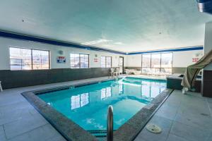 a large swimming pool with blue water in a building at Quality Inn & Suites Vail Valley in Eagle