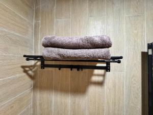 a group of towels on a shelf in a bathroom at Hendi Homestay E No 8 Puriloka1 in Batam Center