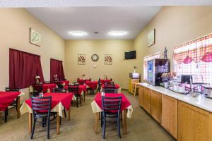 a restaurant with red tables and chairs and a counter at Quality Inn Scottsbluff in Scottsbluff +13 photos