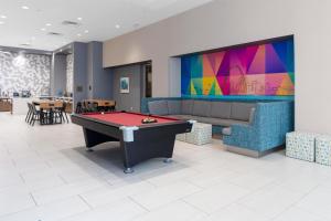a room with a pool table and a tv at Tru By Hilton St Louis Downtown Mo in Saint Louis