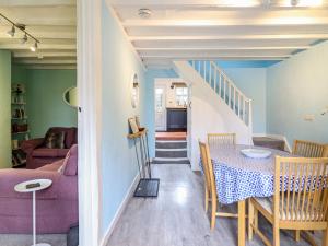 a dining room and living room with a table at Preswylfa in Blaenau-Ffestiniog