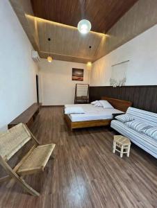 a large room with two beds and a couch at Osaka Villa Phan Thiet in Ấp Bình Hưng +10 photos