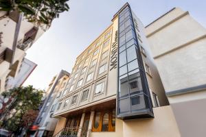 a tall building with glass windows on the side of it at Monday Premium Madhapur in Hyderabad