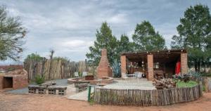 a backyard with a fire pit and a pavilion at Sundown Lodge and Confrence in Aliwal North +22 photos
