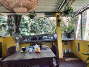a wooden table in a room with plants at Nimal`s Homestay in Hikkaduwa