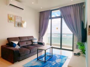 a living room with a couch and a table at GYDEN STAYCATION #Green Haven near Senibong&Regency in Masai