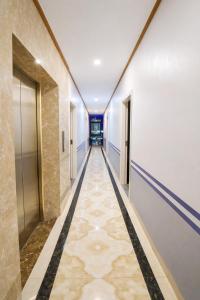 a hallway with a long corridor with doors at Harmony Hotel in Hanoi