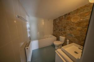 a bathroom with a tub and a toilet and a sink at Farmakas Living in Pharmakas +124 photos
