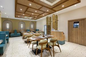 a dining room with wooden tables and chairs at Monday Premium Madhapur in Hyderabad