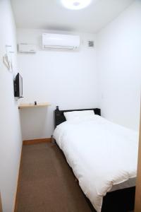 Postel nebo postele na pokoji v ubytování Simple Sleep 個室カプセル + 19 fotografií