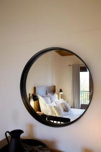 a bedroom with a bed and a mirror on the wall at Levanta in Megalo Chorio