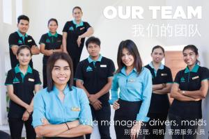 a group of people posing for a picture in a room at Amatapura Beachfront Villa 14, SHA Certified in Ao Nam Mao +34 photos