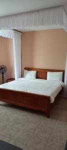 a bed with a canopy in a bedroom at Paran Amboseli Resort in Kimana