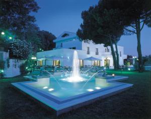 a fountain in front of a house at night at LH Hotel Domus Caesari in Marino