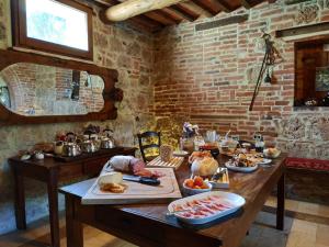 a table with a bunch of food on it at Wild Agriturismo Podere della Bruciata in Chiusi