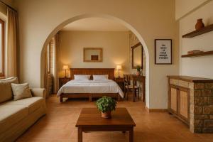 a bedroom with a bed and a couch and a table at Philoxenia in Kavála +39 photos