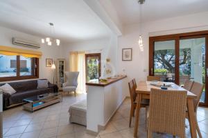 a living room with a couch and a table at Villa Rania - Porto Hydra in Ermioni