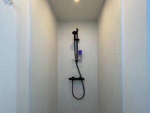 a shower with a black shower head in a bathroom at Logis Fontaines in Champagnat +36 photos