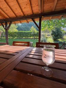 a glass of water sitting on a wooden table at Logis Fontaines in Champagnat