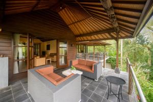 an outdoor patio with chairs and a table at Puri Saron Hotel Madangan - Gianyar in Gianyar