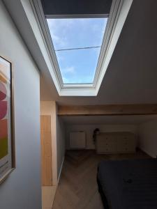a bedroom with a skylight in the ceiling at Logis Fontaines in Champagnat