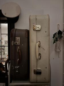 two suitcases sitting next to each other in a room at Sköna Rum Fryksta in Kil