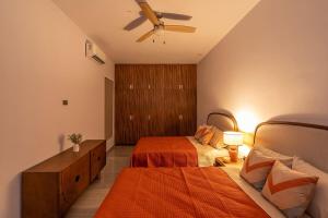 a bedroom with two beds and a ceiling fan at Arch View Luxury Condo with Heated Rooftop Pool and Jacuzzi in Cabo San Lucas
